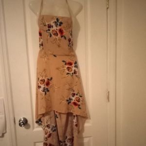 A summer dress with a back open long in the back it's short in the front